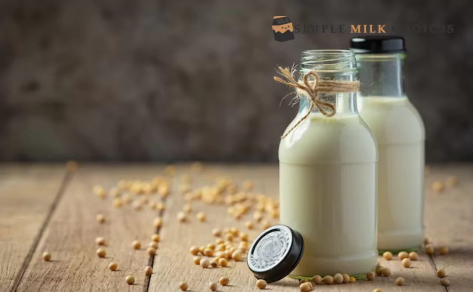 Glass bottle of fresh oat milk ready for refrigeration, placed on a shelf against a white background.
