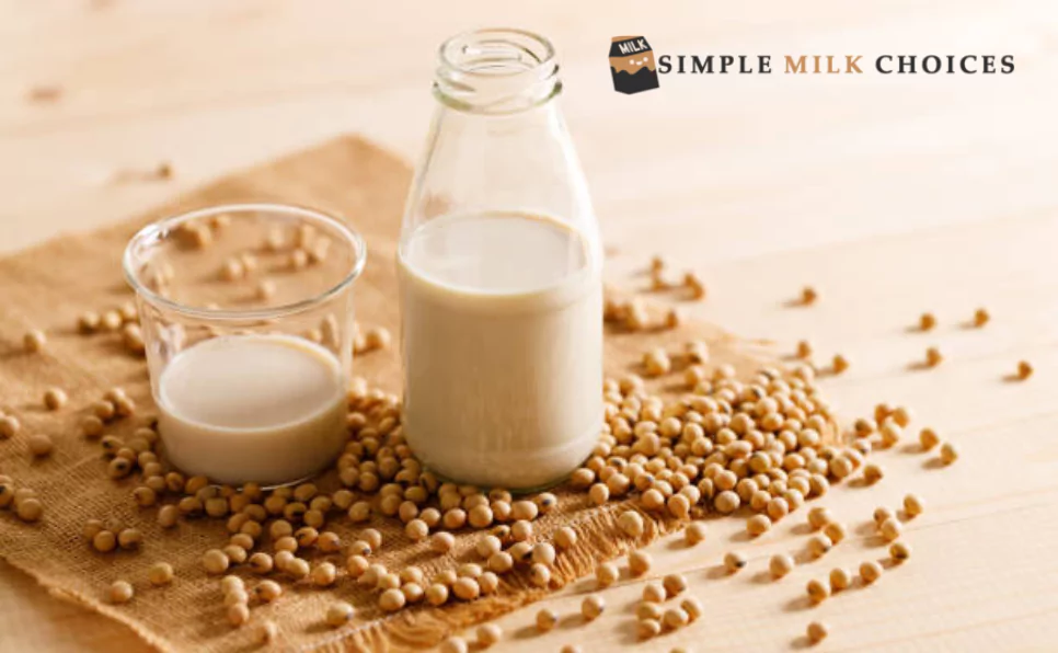 A bountiful display of freshly harvested soybeans dropped in front of a bottle of soy milk and a bowl of soybeans, embodying the journey from field to nutritious beverage.