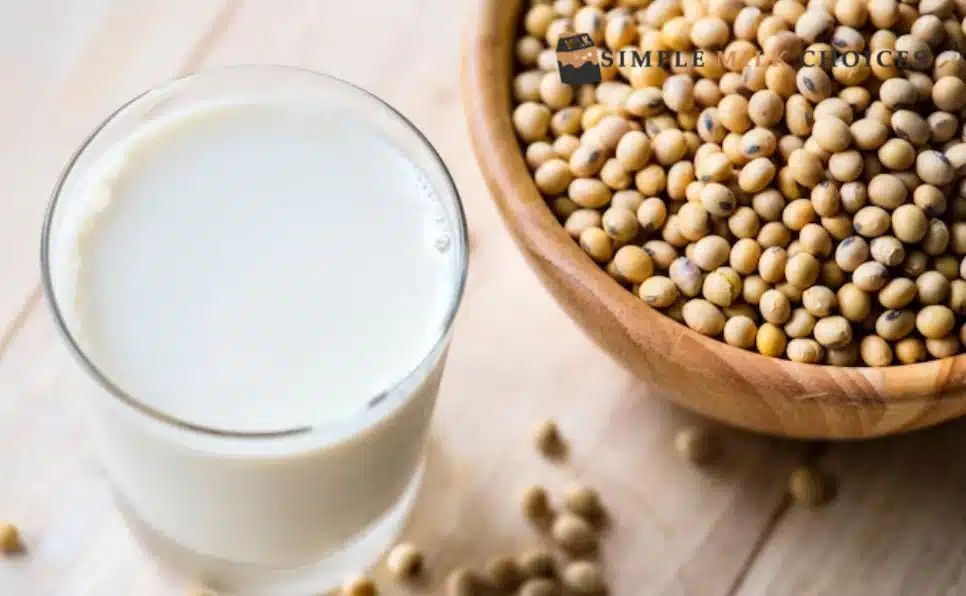 Glass of soy milk and a bowl of soybeans on table, highlighting gluten-free status of soy milk as a dietary alternative.