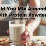 Image showing a person adding protein powder into a glass of almond milk. The glass sits on a kitchen countertop with soft natural lighting, highlighting the mixing process. The person's hand gently pours protein powder into the almond milk, creating a swirl in the liquid.